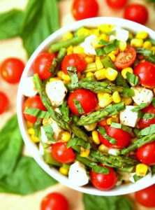 http://www.happygoluckyblog.com/wp-content/uploads/2017/08/Asparagus-Corn-Caprese-Salad-1-1-222x300.jpg